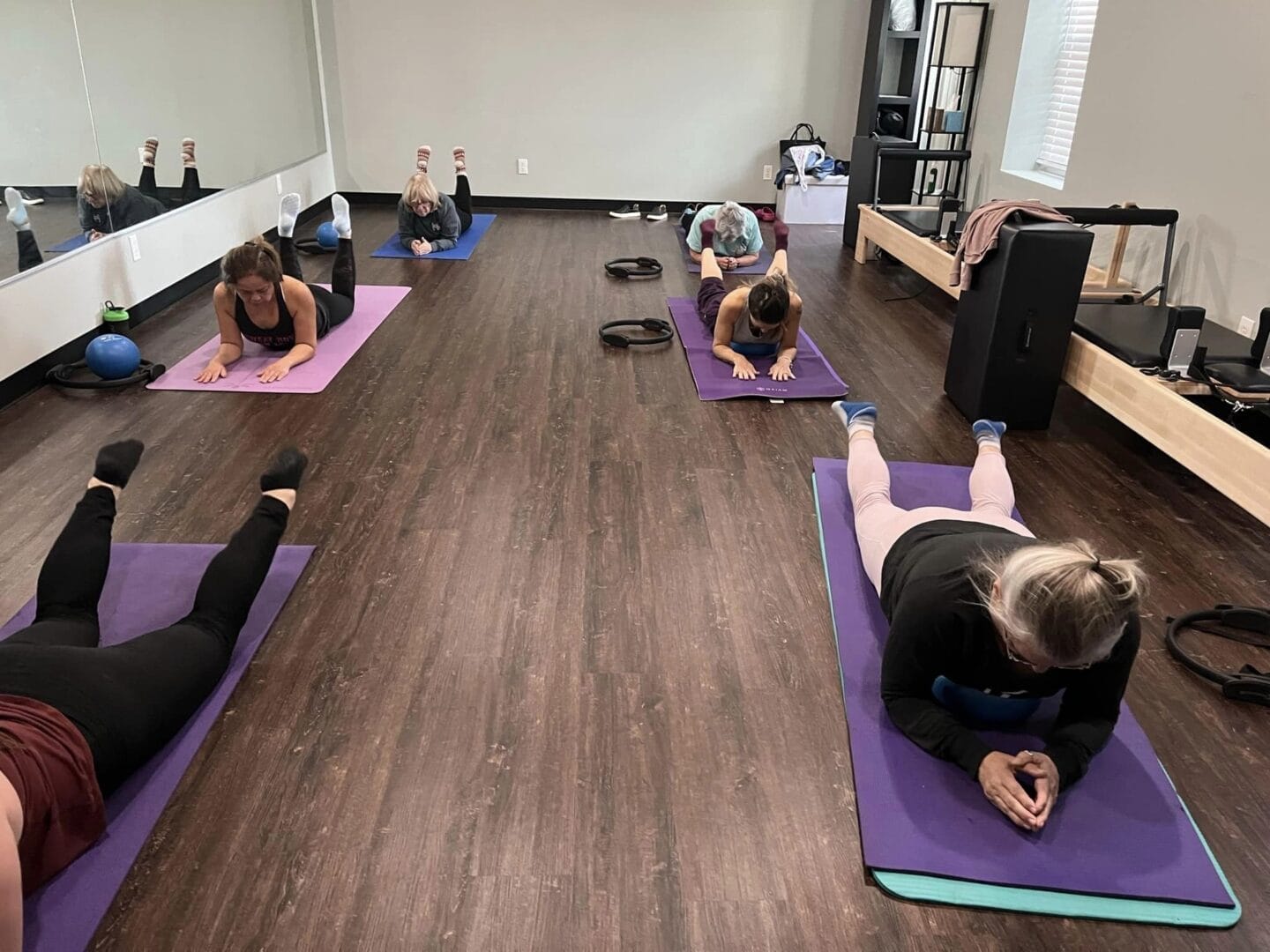 Women doing pilates on a mat at Kainos Community CrossFit